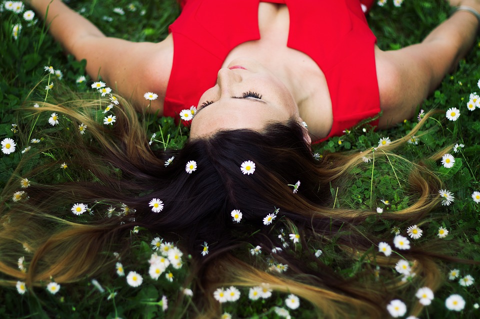 Woman meditating blissfully in the forest